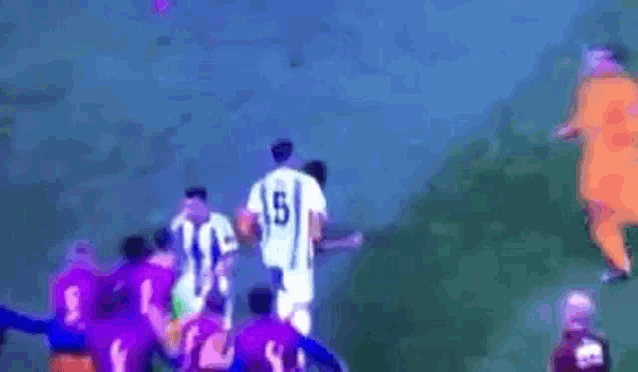 a group of people wearing purple jerseys with the number 9 on them are playing soccer .