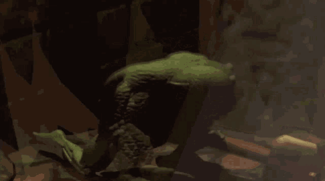 a statue of a monster with a hammer in the background