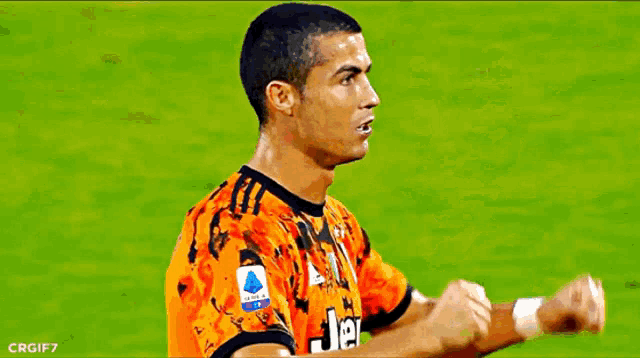 two soccer players are giving each other a high five on a field .