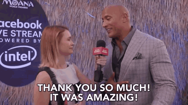 a man in a suit is being interviewed by a woman who is holding a microphone and says thank you so much