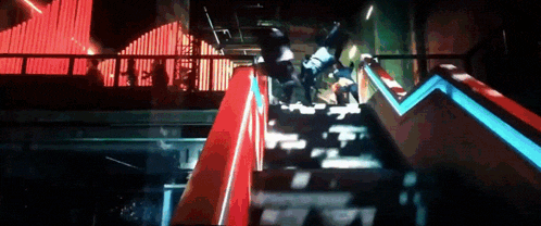 a person is falling down a set of stairs in front of a neon sign that says the end