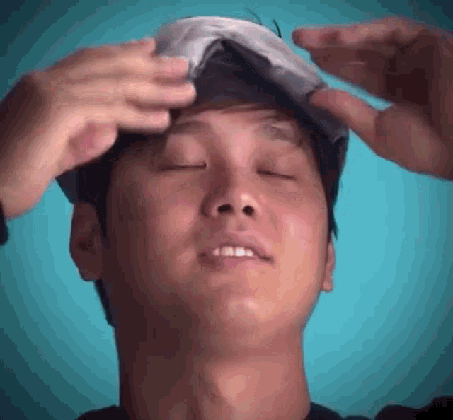 a man with his eyes closed and a bandage on his head