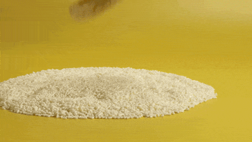 yellow frosting is being piped on a cookie