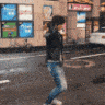 a person is walking down the street in front of a building .