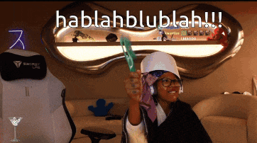 a woman is holding a green object in front of a sign that says habblahblublah