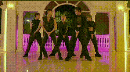 a group of people are standing next to each other in a room .