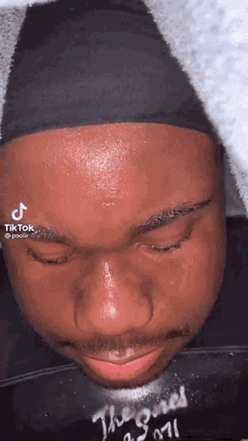 a close up of a man 's face with tiktok written on the bottom right