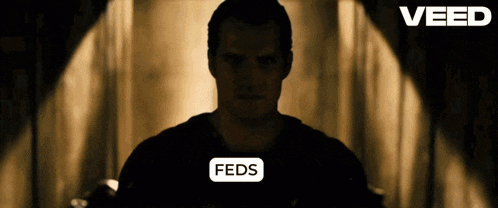 a silhouette of a man with feds written above him