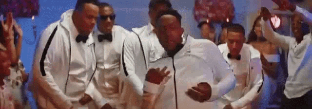 a group of men are dancing together in a room .