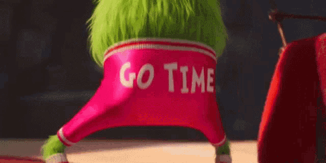 the grinch is wearing pink pants with the words `` go tim '' on the back .