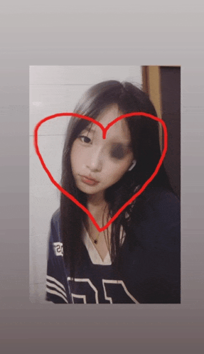 a girl with a black eye has a heart drawn around her face