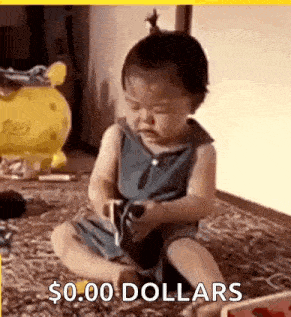 a baby is sitting on the floor playing with a toy and holding a cell phone .