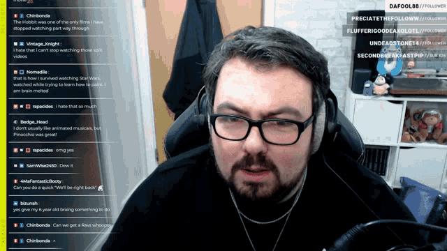 a man wearing glasses and headphones sits in front of a screen that says ' dafol88 ' on it