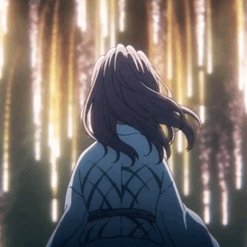 a woman in a kimono is standing in front of a tree with a lot of lights coming out of it .