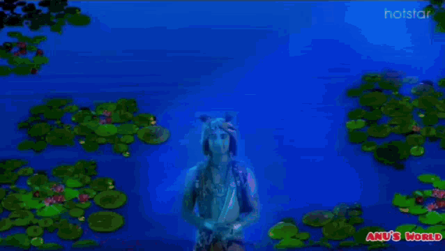 a man in a costume with the words anu 's world on the bottom right