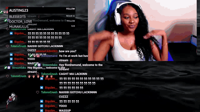a woman wearing headphones is sitting in front of a screen that says austing23 on it