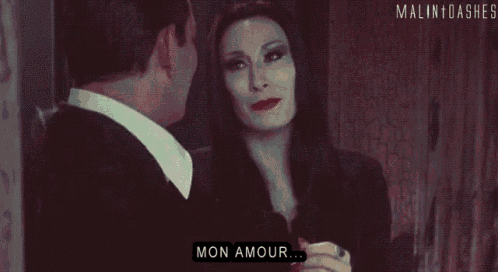 a man and a woman are standing next to each other and the woman is saying mon amour