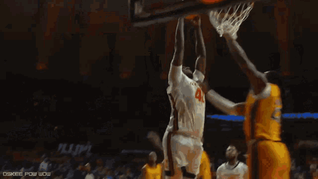 a basketball player with the number 27 on his jersey is being lifted by another player