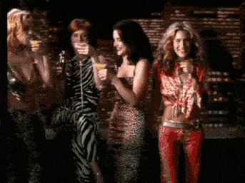 a group of women are having a party and drinking cocktails .