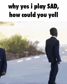 a man in a suit is standing next to another man in a suit on a street .