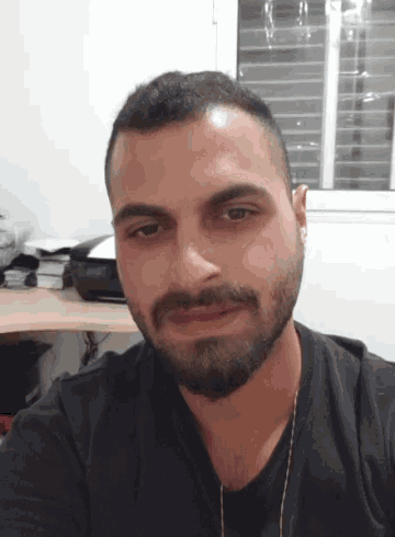 a man with a beard is looking at the camera