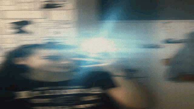 a blurry picture of a person with a light coming out of their face