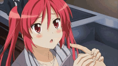 a pixelated image of a girl with red hair pointing at something