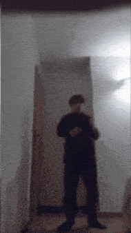a blurry picture of a person standing in a hallway with a door