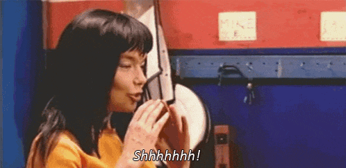 a woman is talking on a cell phone and says shhhh !