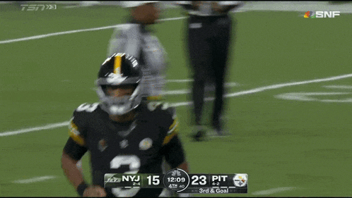 a football player with the number 3 on his jersey runs on the field