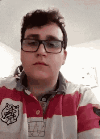 the man is wearing glasses and a red and white striped shirt .