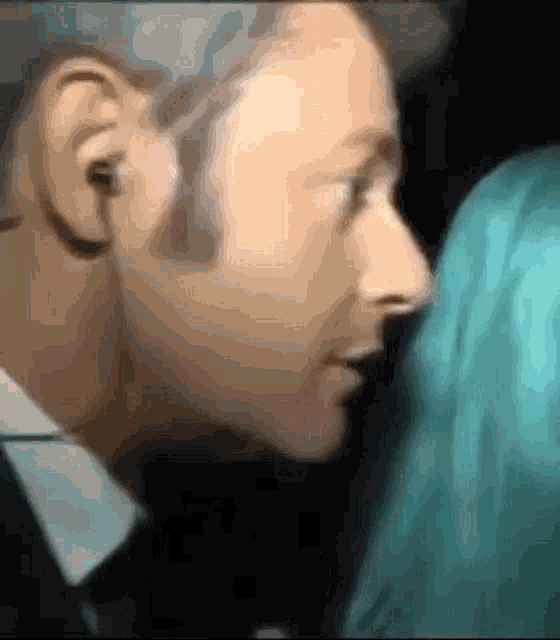 a close up of a man 's face and a woman 's face .