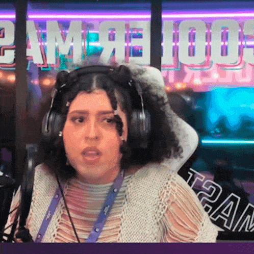 a woman wearing headphones is sitting in front of a sign that says t2am