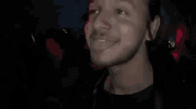 a close up of a man 's face with his eyes closed and his mouth open .
