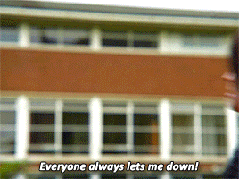 a person says everyone always lets me down in front of a large building