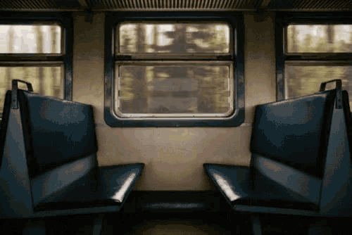 an empty train car with blue seats and a window that says ' eee ' on it