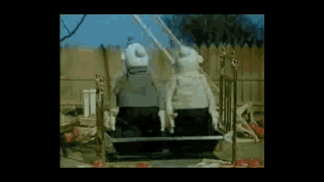 a ladder is falling over a bench filled with tomatoes in a yard .