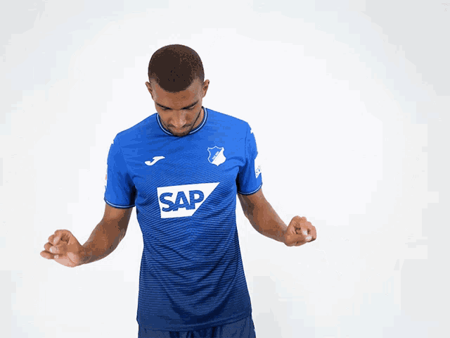 a man wearing a blue shirt with the word sap on the front