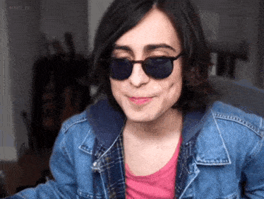 a woman wearing sunglasses and a denim jacket has the hashtag mary_j3 on her face