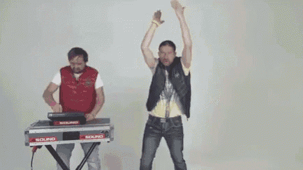 a man is dancing in front of a keyboard with the words `` in never '' written on it .