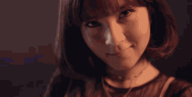 a woman with short hair is wearing a choker