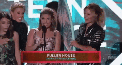 a group of women standing in front of a podium that says fuller house on it