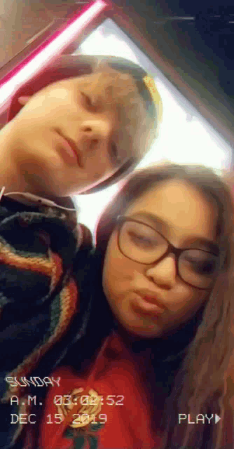 a boy and a girl are posing for a photo on sunday december 15 2019