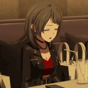 a girl in a leather jacket sits at a table with a straw in her glass