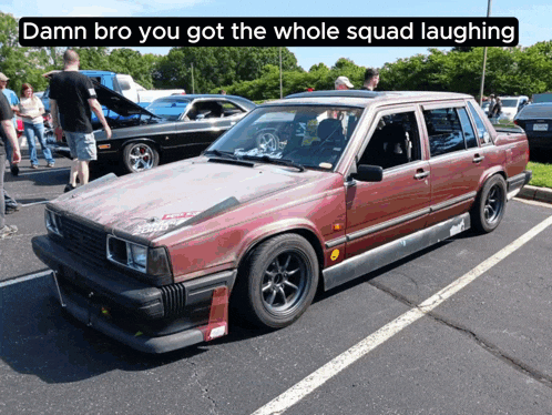 a red car is parked in a parking lot with the caption damn bro you got the whole squad laughing