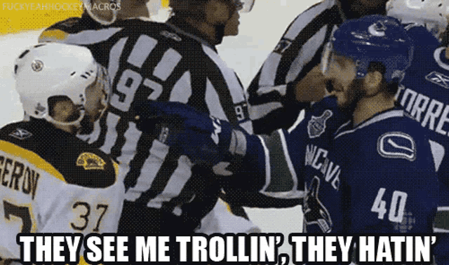 a hockey player with the number 40 on his jersey talks to a referee