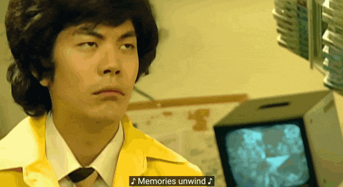 a man in a yellow jacket and tie with the words memories unwind on the bottom