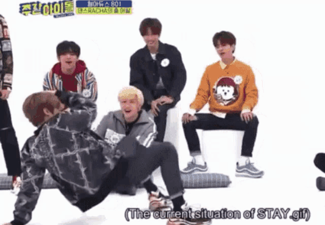 a group of young men are playing a game and one of them says " the current situation of stay girl "