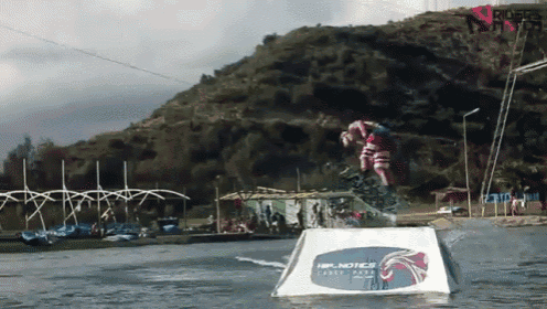 a person is jumping over a water obstacle that says hip notices