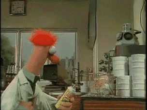 a muppet is holding a bottle of ketchup
